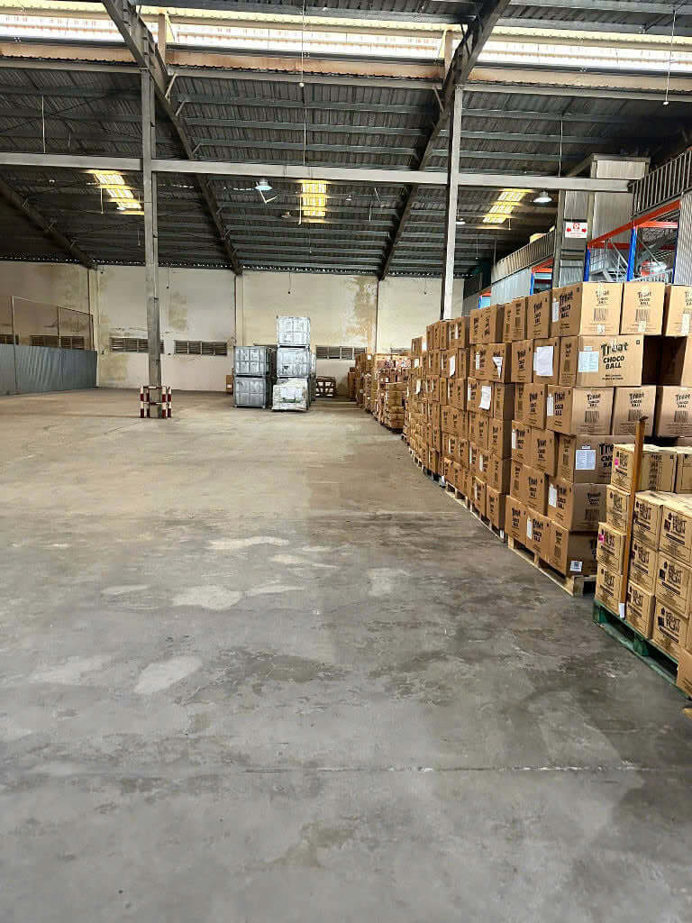 Budget-friendly logistics warehouse with secure fencing and surveillance